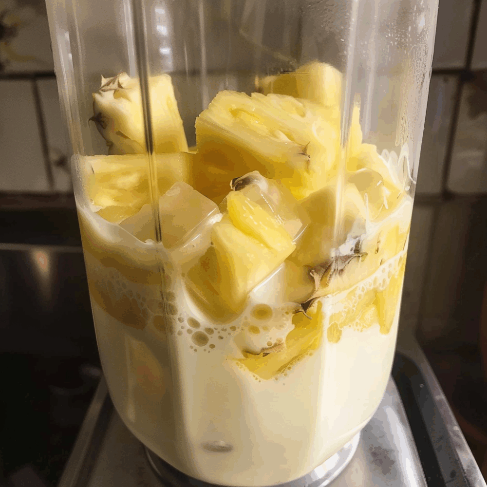 Easy Coconut Pineapple Smoothie With Coconut Milk: Irresistibly Delicious 8 fresh pineapple, coconut milk, and ice cubes in a blender for coconut pineapple smoothie